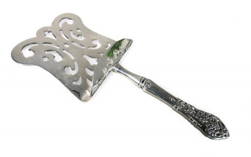 Reed and Barton Asparagus Server: A lovely asparagus server by Reed and Barton. The pierced scoop is plated; only the handle is sterling and marked. Dimensions: 9.25 x 4 in.. Condition: Sterling handle clean and unmarked.