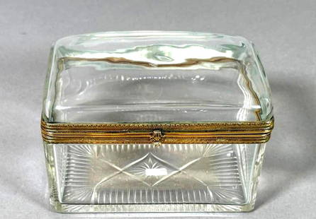 French Crystal Box with Bronze Mounts: French Crystal Box with Bronze Mounts, rectangular form with domed cover in clear crystal with engine turned mounts and scallop shell clasp, the base cut with a star and fan pattern. Dimensions: