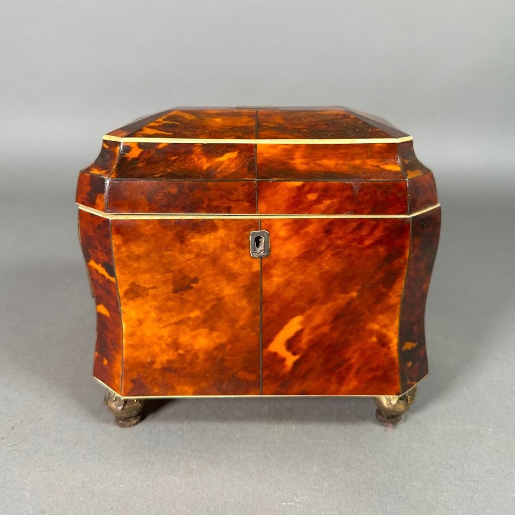 English Regency Period Shell Veneered Tea Caddy, Early 19thc.: English Regency Period Shell Veneered Tea Caddy, Early 19thc. Shaped top with inset silvered plate over a slightly waisted form with silvered escutcheon, veneered in shell and line inlaid, the hinged 