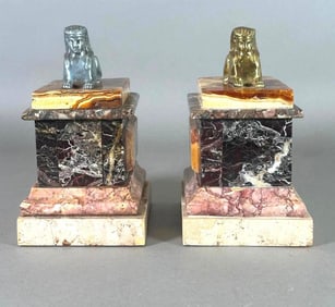 A Pair of Marble Bookends with Sphinx Surmounts