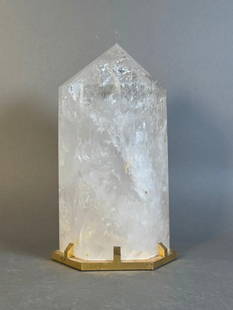 Modern Rock Crystal Obelisk in Gilt Bronze Mount: Modern Rock Crystal Obelisk in Gilt Bronze Mount, the slightly uneven hexagonal form fitted into a conforming modernist gilt bronze base. Dimensions: 10.75 in.h. x 6 in.w. Condition: Scattered small f