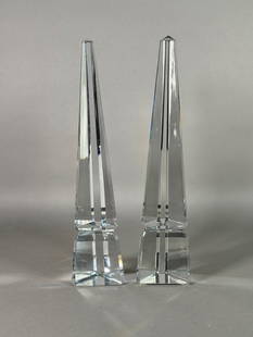 Pair of Baccarat Crystal Louxor Obelisks: Pair of Baccarat Louxor Crystal Obelisks, each signed with acid stamp signature. Dimensions: 10.25 in.h. Condition: One obelisk with chip to foot and one edge of obelisk.