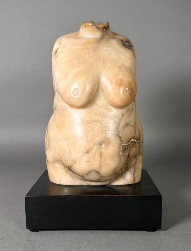 Carved Marble Female Torso, 20thc., Modern: Carved Marble Female Torso, 20thc, Modern. Polished beige marble with brown and gray veining depicting a nude female torso, raised on a rectangular laminate base. Unsigned. Dimensions: 9.5 x 6 x 4 in.