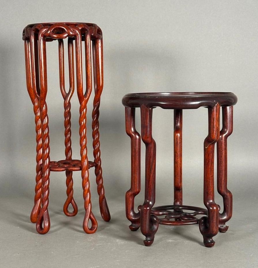 Two Chinese Hardwood Vase Stands: Two Chinese Hardwood Vase Stands, The shorter in rosewood with circular top and stylized scroll legs joined by a circular openwork stretcher, the second taller, with rope twist legs Dimensions: 9.5 in