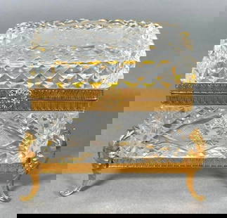 Cut Crystal Box with Gilt Metal Mounts: Cut Crystal Box with Gilt Metal Mounts, cut with a star pattern reserved on a diamond cut ground, with gilt mounts, raised on gilt metal scrolled feet. Dimensions: 4.25 x 4 x 2.5 in. Condition: Small