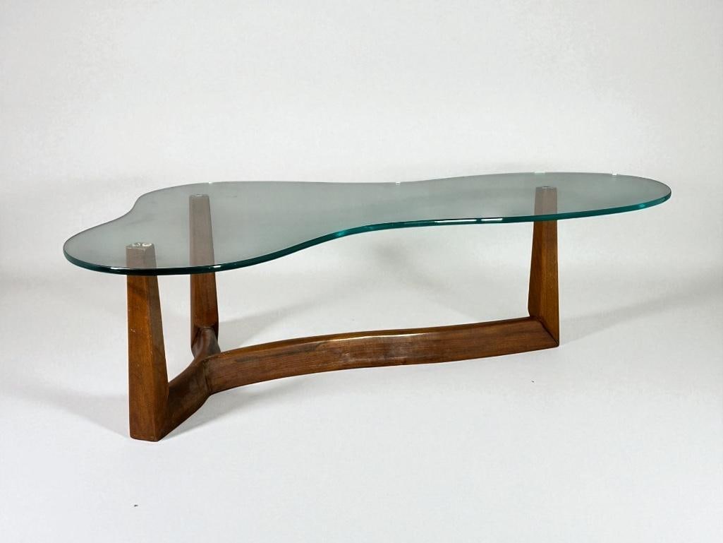 T.H. Robsjohn-Gibbings For Widdicombe Biomorphic Coffee Table, ca. 1950's: T.H. Robsjohn-Gibbings Style Biomorphic Coffee Table, manufactured by Widdicomb ca. 1950's, organic form tripod base in walnut with shaped glass top. No tag.Provenance: Collection of Sam Botero and Em