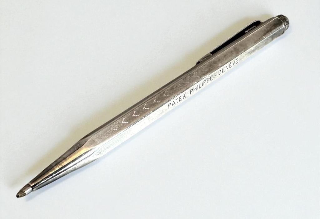 Patek Philippe Silver Plated Ball Point Pen: Patek Philippe Silver Plated Ball Point Pen, with engine turned details, stamped Patek Philippe-Geneve and Swiss Made + Caran D'Ache. Dimensions: 5 in.l. Condition: Good with light wear and tarnish.