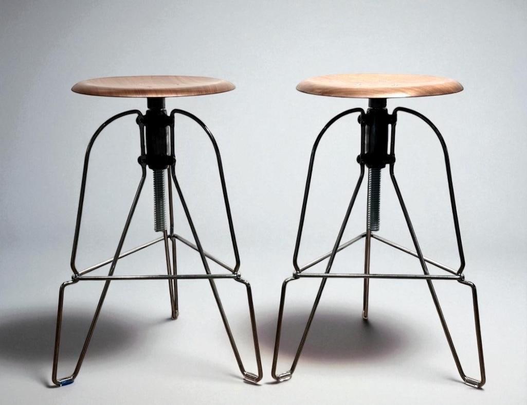 Pair of Jeff Covey Adjustable Stools: Pair of Jeff Covey Adjustable Stools, Covey Model Six, designed in 1997, with laminated walnut seats raised on a cast aluminum adjustable tripod base, stamped signatures to underside of seat. Dimensio