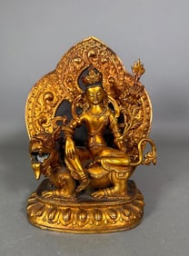 Tibetan Gilt Metal Figure of The Green Tara on a Lion