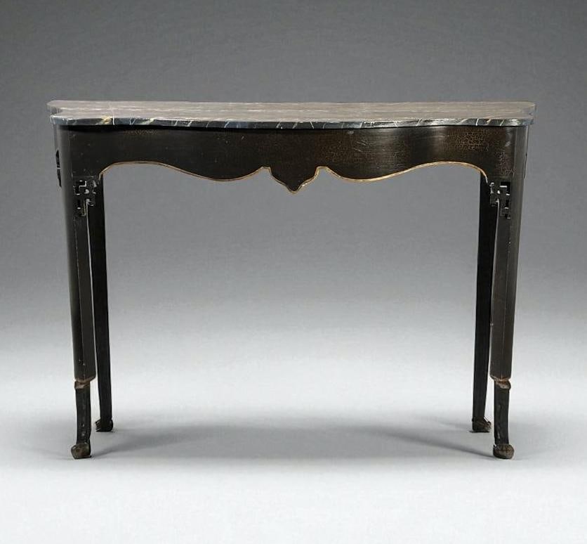 Minton-Spidell Ebonized and Faux Marbre Console Table: Minton-Spidell Ebonized and Faux Marbre Console Table, with serpentine shaped top hand painted in faux marbre in blue, tan and white on the ebonized ground, over a shaped frieze with fretwork at the r