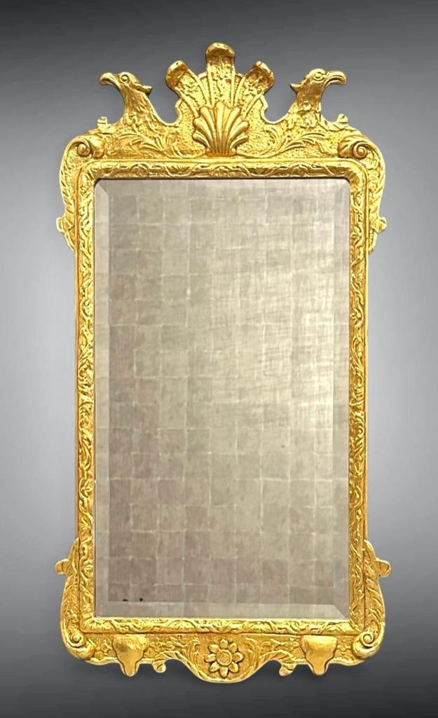 George I Style Gilded Wall Mirror, Colonial Williamsburg Reproduction: George I Style Gilded Wall Mirror, Colonial Williamsburg Reproduction, with scallop and palmette crest and eagle's heads flanking, framing a rectangular beveled mirror plate, the obverse with label fo