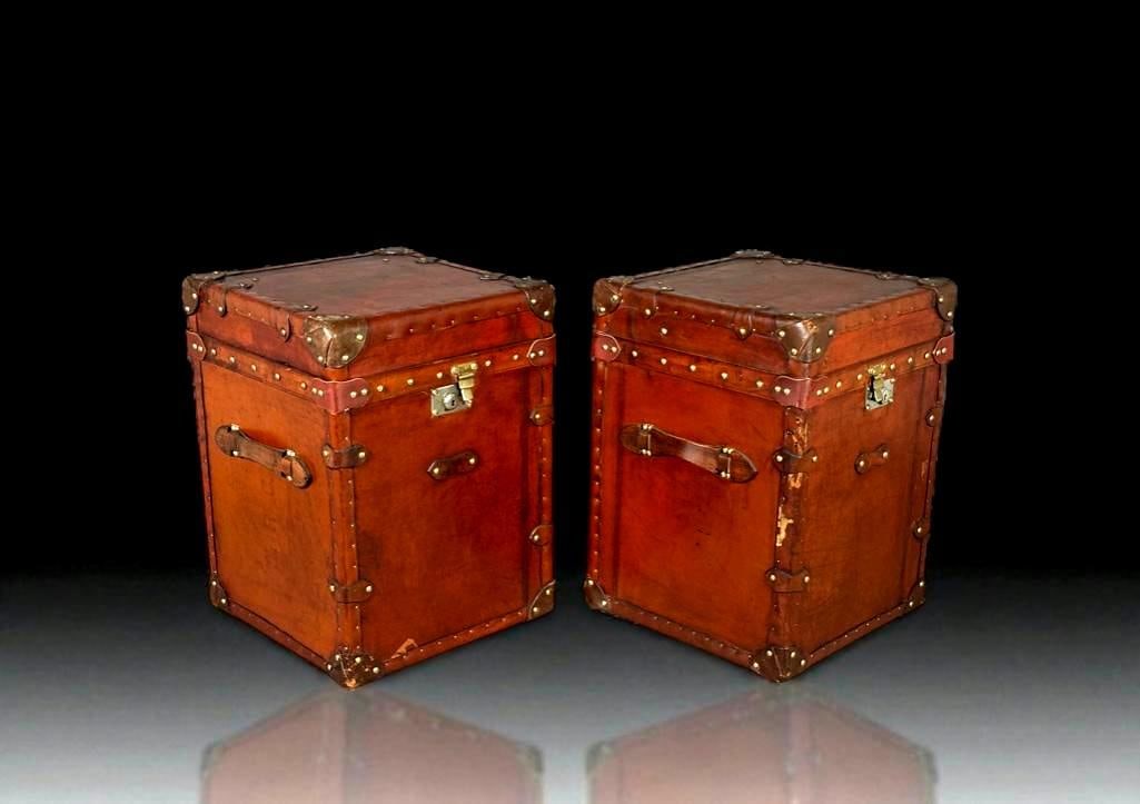 Pair of Leather Upholstered Decorative Trunks, Modern: Pair of Leather Upholstered Decorative Trunks, Modern. Squared forms with applied brown leather strapwork and brass nail head studs. Dimensions: 22 x 16 x 16 in. Condition: Some wear to leather from u