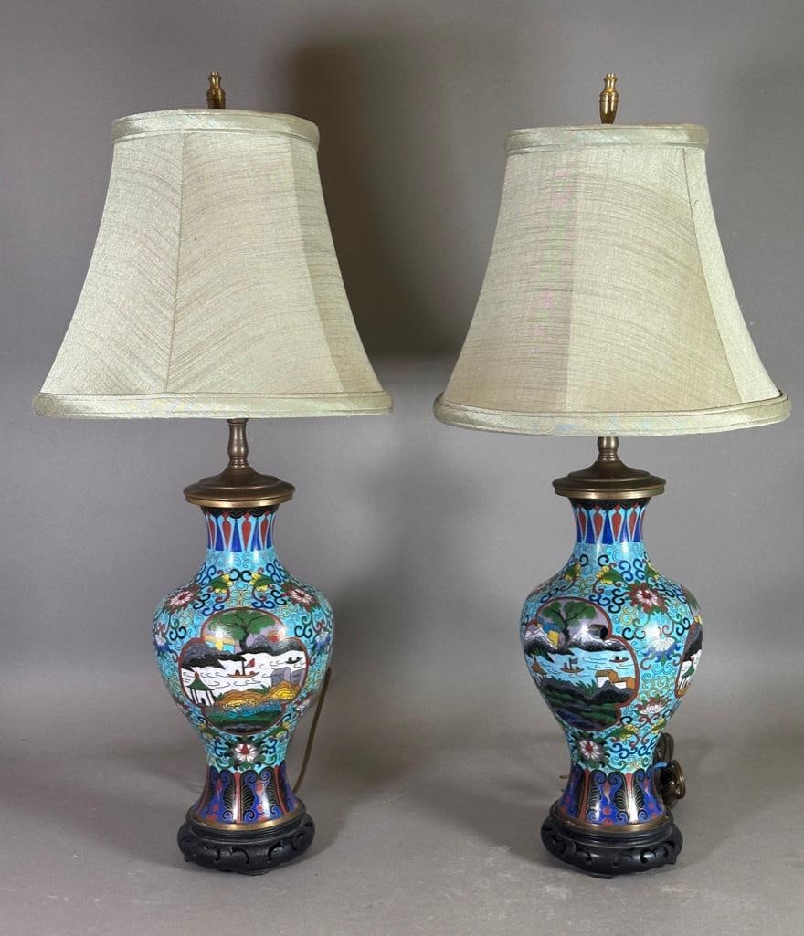 A Pair of Chinese Cloisonne Enamel Lamps: A Pair of Chinese Cloisonne Enamel Lamps, a matched pair of baluster form table lamps, each with vignettes of the seasons reserved on a turquoise floral scroll ground, with lappet borders, raised on a
