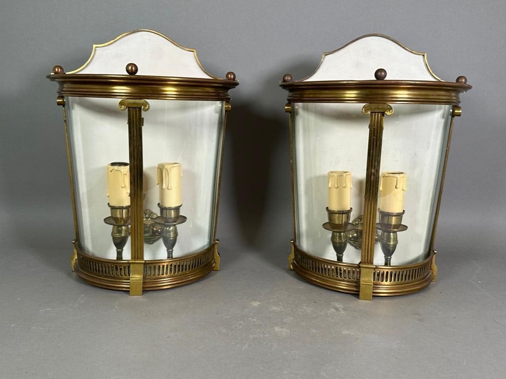 Pair of Neoclassical Lantern Wall Sconces: Demi-lune two curved glass front panels in brushed brass frame with lower gallery, Ionic columns, the interior having two lights, electrified, wall mount, white painted interior. Apprx 15"T x 11.5"W x