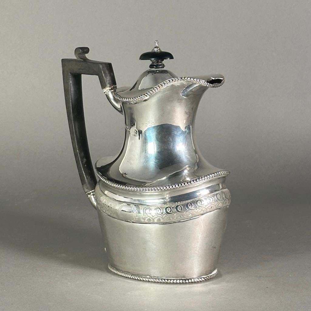English Sterling Silver Jug, Sheffield, 1918, Mappin and Webb: English Sterling Silver Jug, Sheffield, 1918, Mappin & Webb, shouldered form with engraved border, hinged cover and ebony handle. Dimensions: 8.25 in.h. Condition: Good condition with normal wear from