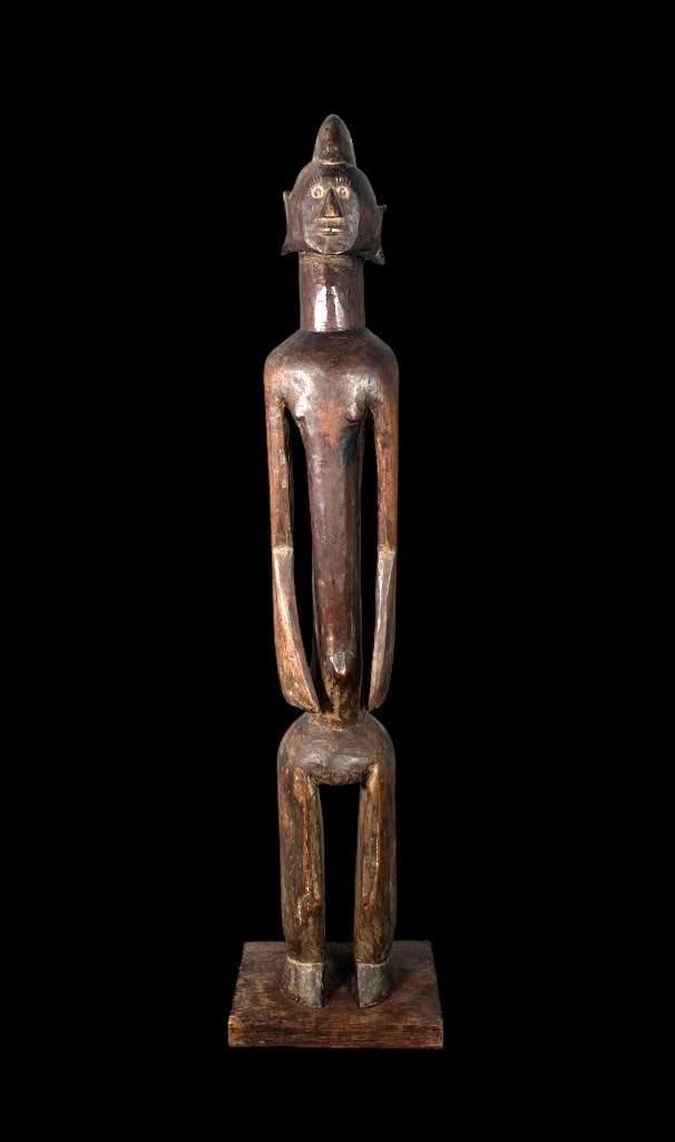 African Senufo Carved Wood Rhythm Pounder Figure: African Senufo Carved Wood Rhythm Pounder Figure, elongated stylized form with long arms and stylized features, mounted to a later wood base. Dimensions: 35.5 in. h. Condition: Possibly once had a col