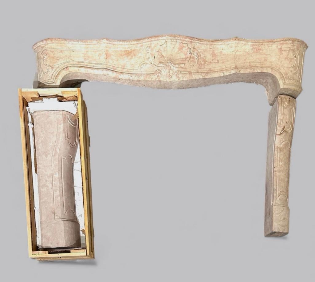 Antique French Regence Style Marble Mantelpiece: Antique French Regence Style Marble Mantelpiece, 18th-19thc. Carved in pink and buff colored marble with a honed finish, the serpentine top centered by a relief carved scallop shell and foliate tendri