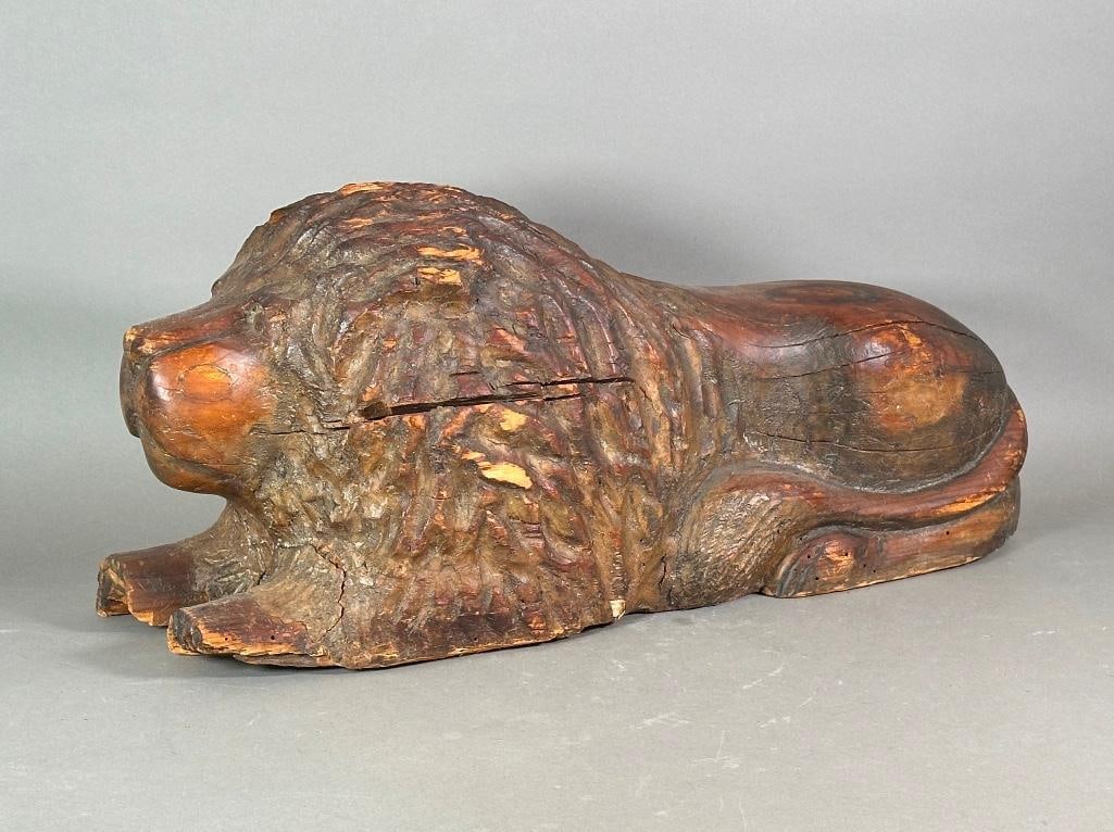 Continental Carved Wood Lion, 18th Century, Ex. Mario Buatta Collection: Recumbent lion, carved of solid wood. With losses throughout. Measures apprx 12''h x 28''l x 10-1/2''w. Provenance: From the collection of NYC designer Mario Buatta.