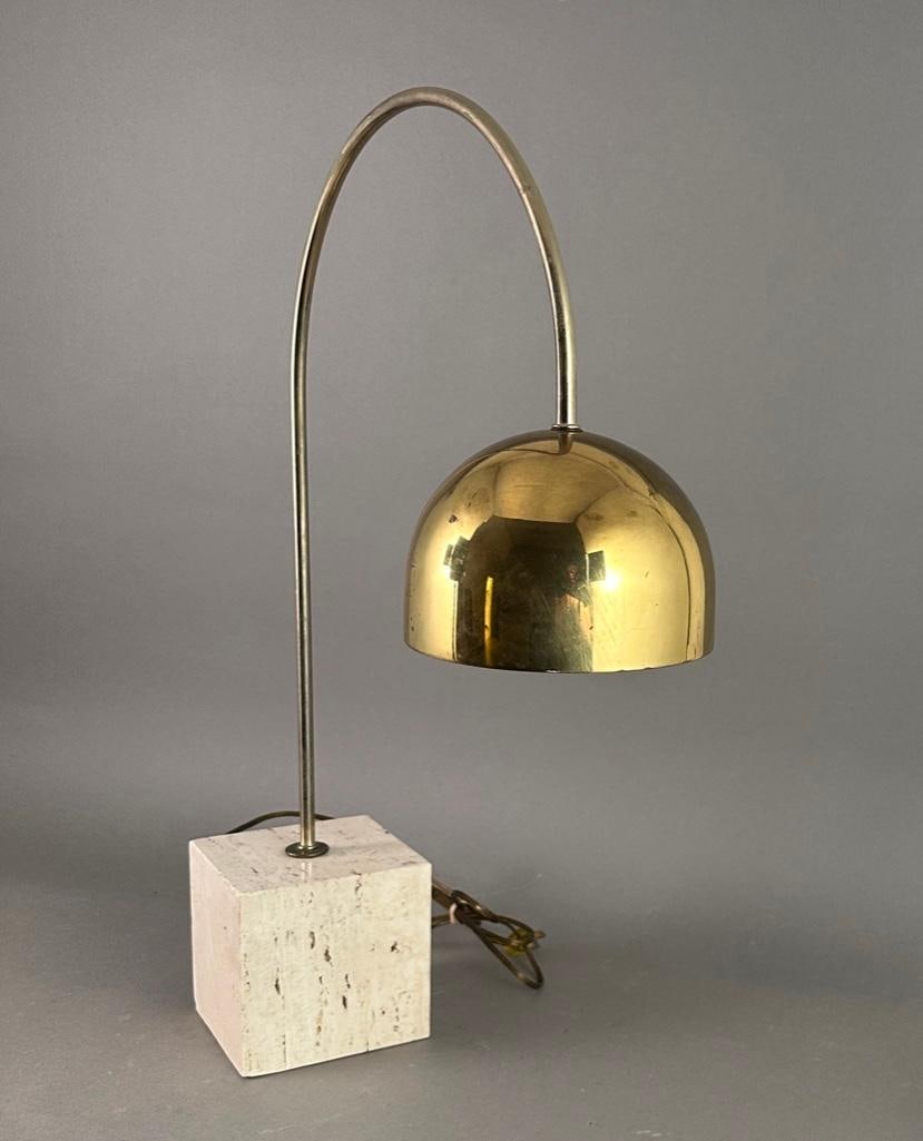 Italian Mid-Century Modern Arc Table Lamp by Harvey Guzzini: Brass, chrome and travertine desk lamp by Harvey Guzzini. Brass arc with brass dome shade anchored by Travertine cube, measuring apprx 5" x 5" x 5". Height: 18.5 in (46.99 cm) Width: 6 in