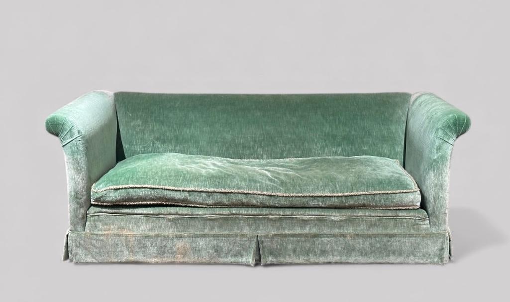 Green Velvet Upholstered Sofa, Modern: Green Velvet Upholstered Sofa, Modern. With high back and scroll arms over a single bench cushion and box pleated skirt. Dimensions: 32 in.h. x 56 in.w. x 33 in. d. Condition: Upholstery worn and with