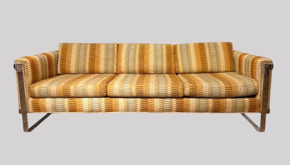 Milo Baughman Three Seat Chrome Sofa: Chrome strap frame, upholstered in original Jack Lenor Larsen striped woven wool. Seating for three people. Measures apprx 26"T x 7'2"L x 33"D. Condition: small brown stain, light wea