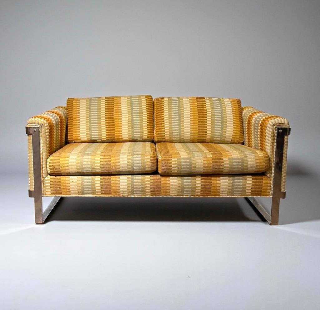 Milo Baughman Chrome Sofa For Two: Chrome strap frame, upholstered in original Jack Lenor Larsen striped woven wool. Measures 26"T x 5'1-1/2"L x 33"D. Condition: light wear from use, recommending professional cleaning.