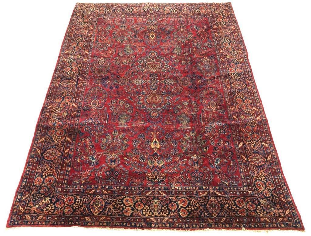 Vase Design Sarouk Carpet, 12' x 9': Sarouk Carpet, 12' x 9'. Thick and soft medium pile wool on cotton weft. Cherry red ground with overall busy floral design with flowering branches, vases, palmettes within a dark blue/black bo
