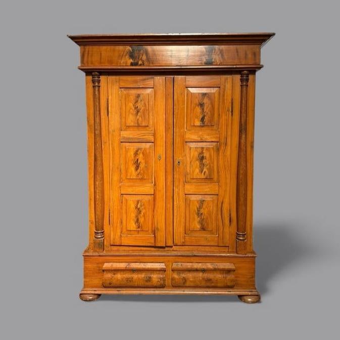 Pine and Faux Bois Finish Architectural Cabinet: Pine and Faux Bois Finish Architectural Cabinet, c.1900, in two parts, the top section with molded cornice over a faux bois figured frieze and two paneled doors with faux bois decorated engaged pilast