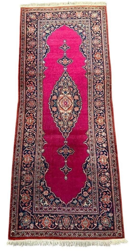 Kashan Runner 5'5" x 2'2": Kashan Runner 5'5" x 2'2", ruby red runner with a lozenge shape medallion within arabesque framework in dark blue and accent colors, wide vine-scroll border with newer fringe ends added.