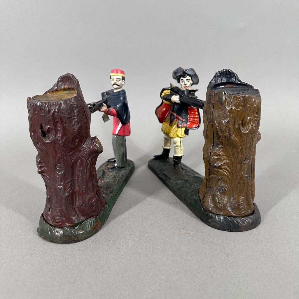 Two Creedmoor Cast Iron Mechanical Banks: Two Creedmoor Cast Iron Mechanical Banks, Bowen's Series, 1901 and New Creedmore featuring William Tell, by J. & E. Stevens, Cromwell, Connecticut. Dimensions: 7 in.h. x 10 in.l. x 2.5 in.d.