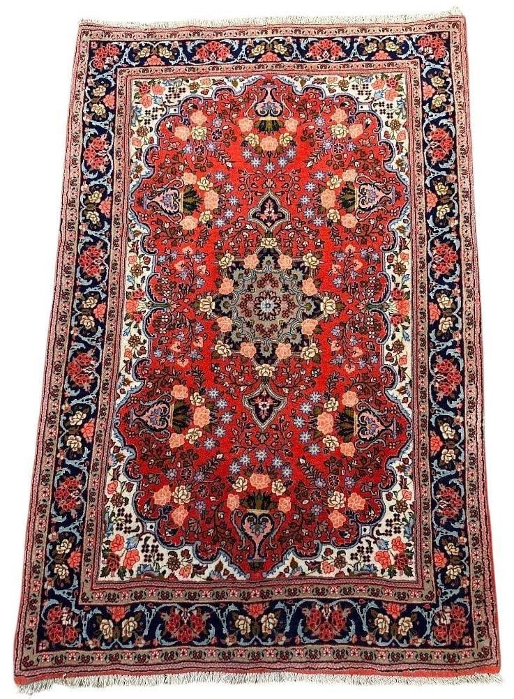 Sarouk Carpet 5'3" x 3'9": Sarouk Carpet 5'3" x 3'9", wool on cotton weft, vinyl supports backing salvege, short fringe ends, Flower and vase design in main field, cream color corner guards, dark blue vine scroll border with