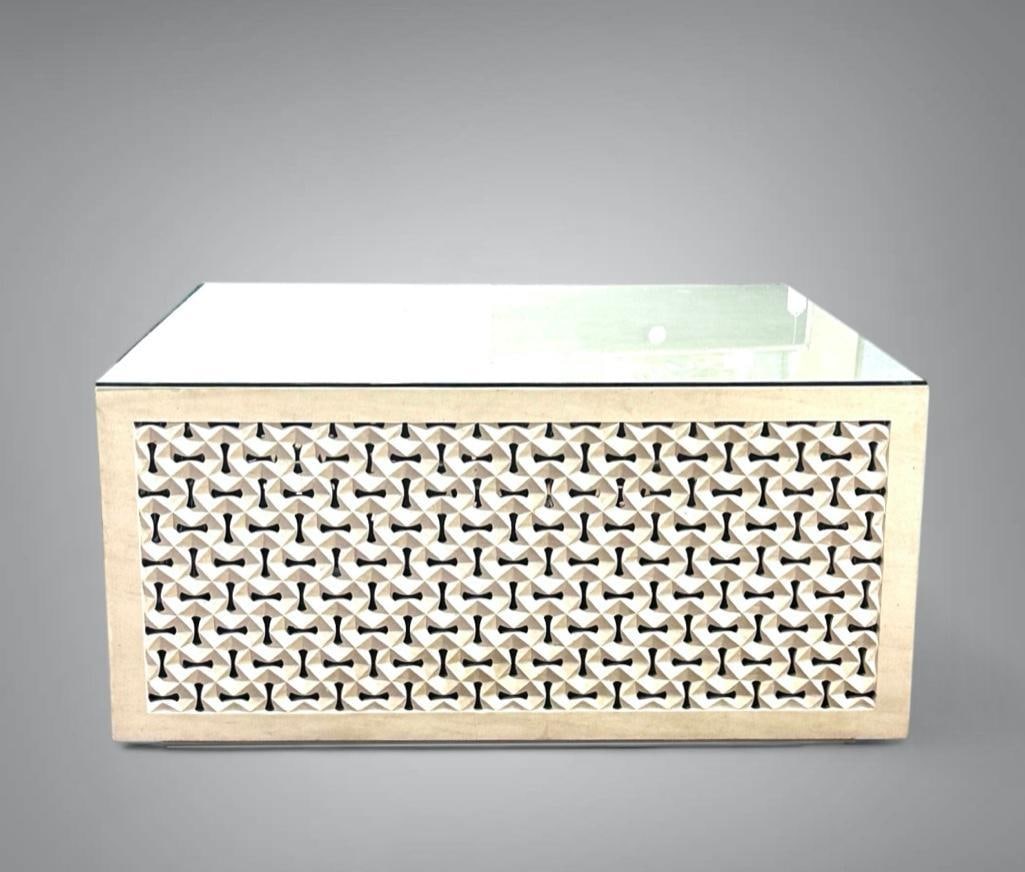 'Toggle' Coffee Table in Cast and Cut Limestone: 'Toggle' Coffee Table in Cast and Cut Limestone, squared form with flat top over a geometric design openwork base. With glass top. Dimensions: 19.75 x 40 x 40 in. Condition: Very good with