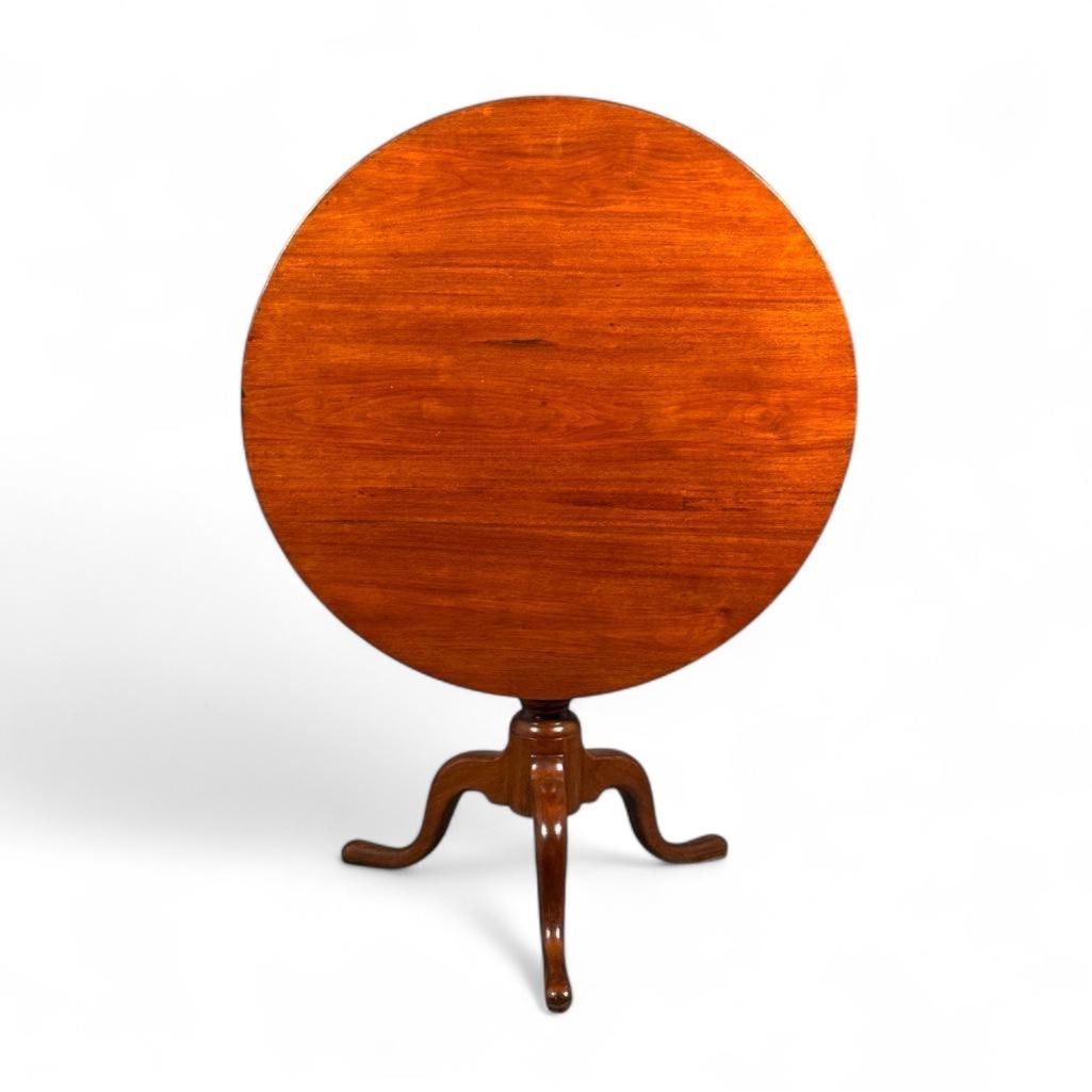 Bird-cage Tilt-Top Table: Tilt-top tea table, walnut, round top with smooth edge, on pedestal base, tri-pod base with flat duck pad feet. Refinished overall, this table has a slight dark spot on top along seam and at edge at