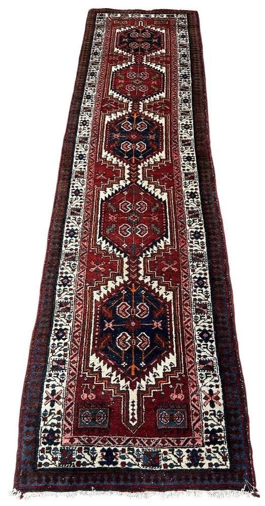 Vintage Karajeh Runner, 10'10" x 2'11": Wool on cotton foundation, primary colors of dark blue and red with white. Five lozenge shaped medallions, outlined in white saw-tooth edge, on a red field, three borders, no fringe ends, thick and pl