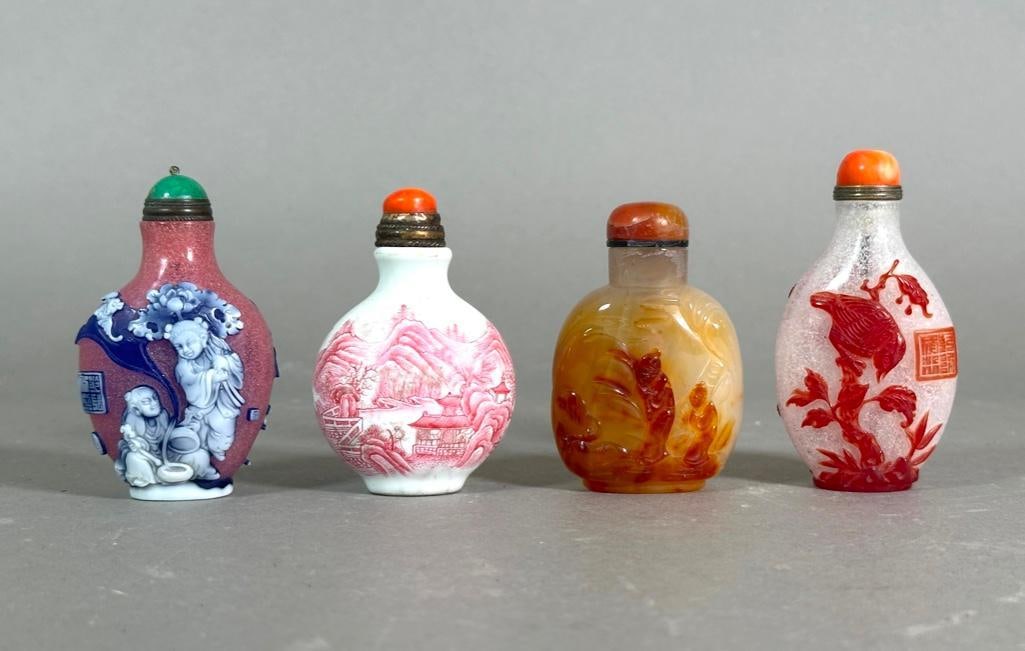 Four Assorted Chinese Snuff Bottles: Four Assorted Chinese Snuff Bottles, Modern, comprising; a Peking Glass style bottle in three layers carved with immortals in blue and white on a pink bubble glass ground, with inscriptions; a Peking