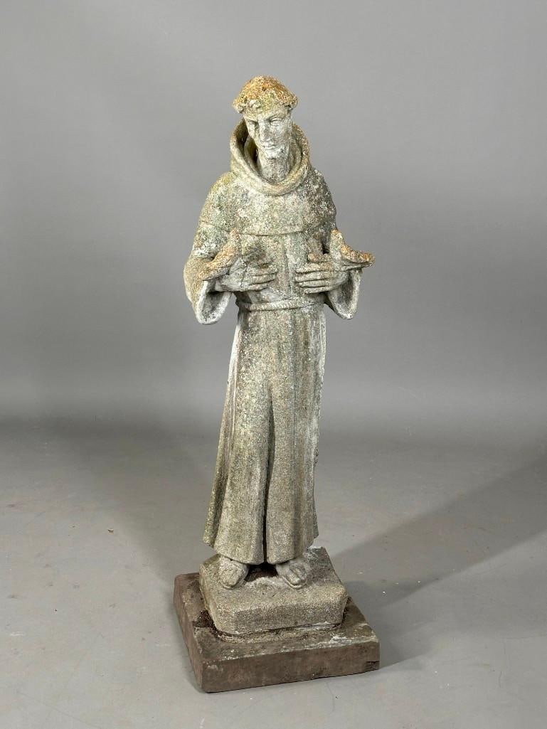 Cast Stone Garden Figure of St. Francis: Cast Stone Garden Figure of St. Francis, the robed monk standing, holding a pair of birds. Dimensions: 38in.h. on 12 x 12 in. base. Condition: Good with outdoor wear.