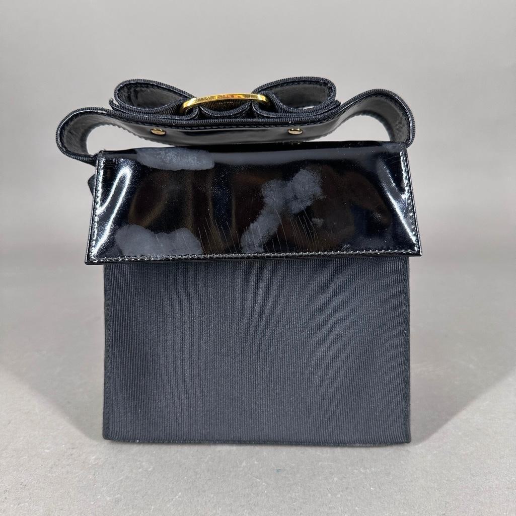 Authenticated Vintage Salvatore Ferragamo Vala Bag: Authentic Salvatore Ferragamo purse with adjustable shoulder strap; patent leather back and flap with black canvas front and sides, gold tone hardware including snap closures, bow handle with the sign