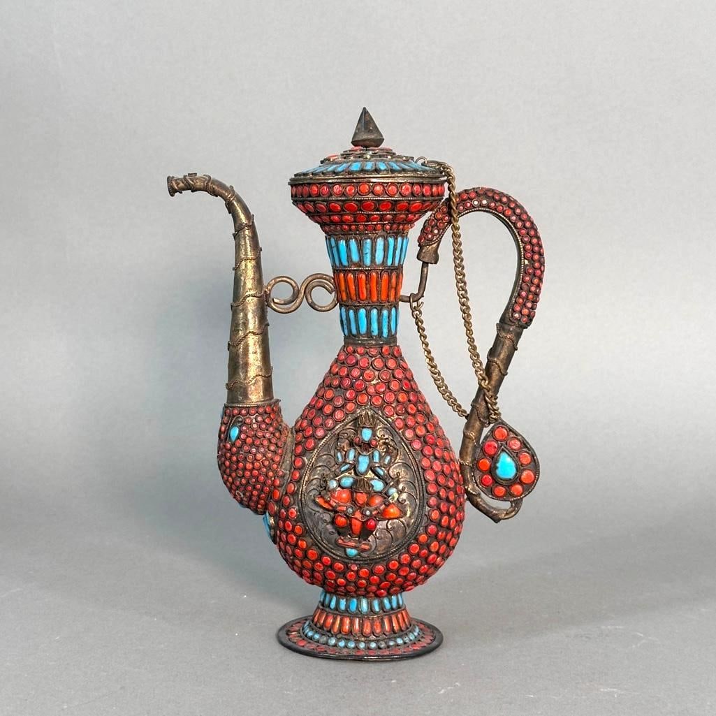 Tibetan Coral and Turquoise Encusted Ewer: Tibetan Coral and Turquoise Encrusted Ewer, pear shaped form on circular foot, with scroll hand;es and spout, decorated to the front and back with Buddhist figures fashioned from turquoise and coral i