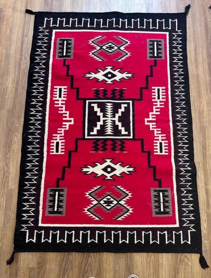 Navajo Woven Wool Carpet, 6'1 x 4'1: Navajo Woven Wool Carpet, storm pattern, red field scattered with lightning symbols and other geometrics in brown, cream, and gray, with border and tassels to each corner. Dimensions: 6'1 x 4'