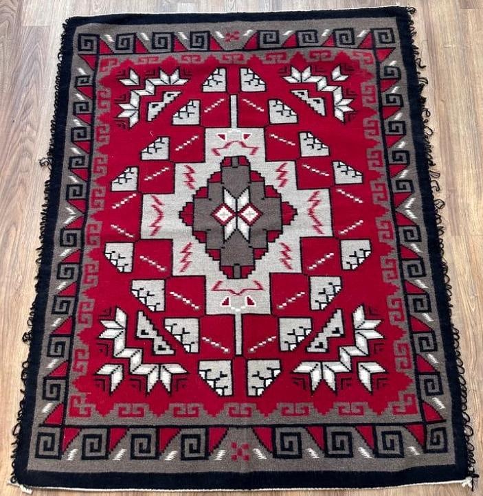Navajo Woven Wool Carpet, 4'8 x 3'9: Navajo Woven Wool Carpet, center geometric medallion with multiple symbols radiating in deep red, black, cream and gray. Loop fringe on both long sides. Dimensions: 4'8 x 3'9 Condition: Very g