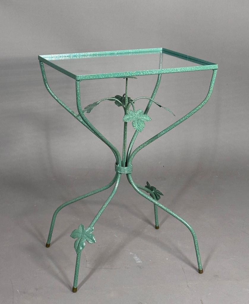 Small Green Painted Garden Table with Glass Top: Small Green Painted Garden Table with Glass Top, rectangular top with inset glass, on a gathered metal base accented with applied leaves. 23 x 15.5 x 12.5 in. Condition: Very good with no damage or
