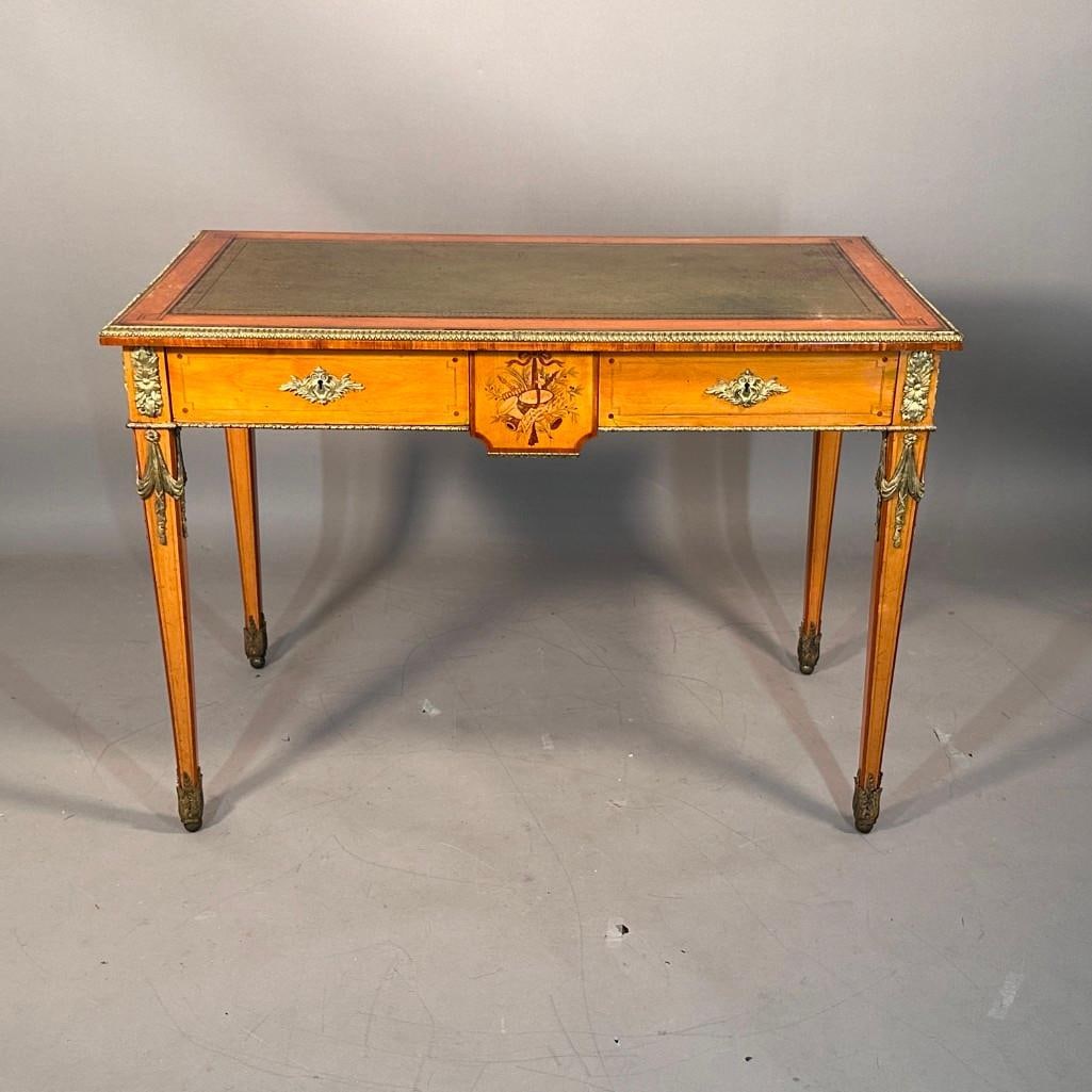 Small Louis XVI Style Writing Table, English, ca. 1850: Small English writing table, Louis XVI style with satin-wood and marquetry inlays with ormolu mounts. Tapered legs and two short drawers, stamped Holland & Sons on the edge of a drawer, with a gre