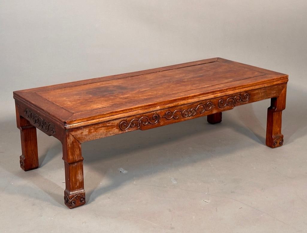 Chinese Huanghuali Kang Table, 18th century: Carved hardwood low profile table; carved cabriole legs with lingzhi decorated feet, two-board top set into a mitered, mortise and tenon frame over shaped aprons carved in high relief. Apprx 12.25"
