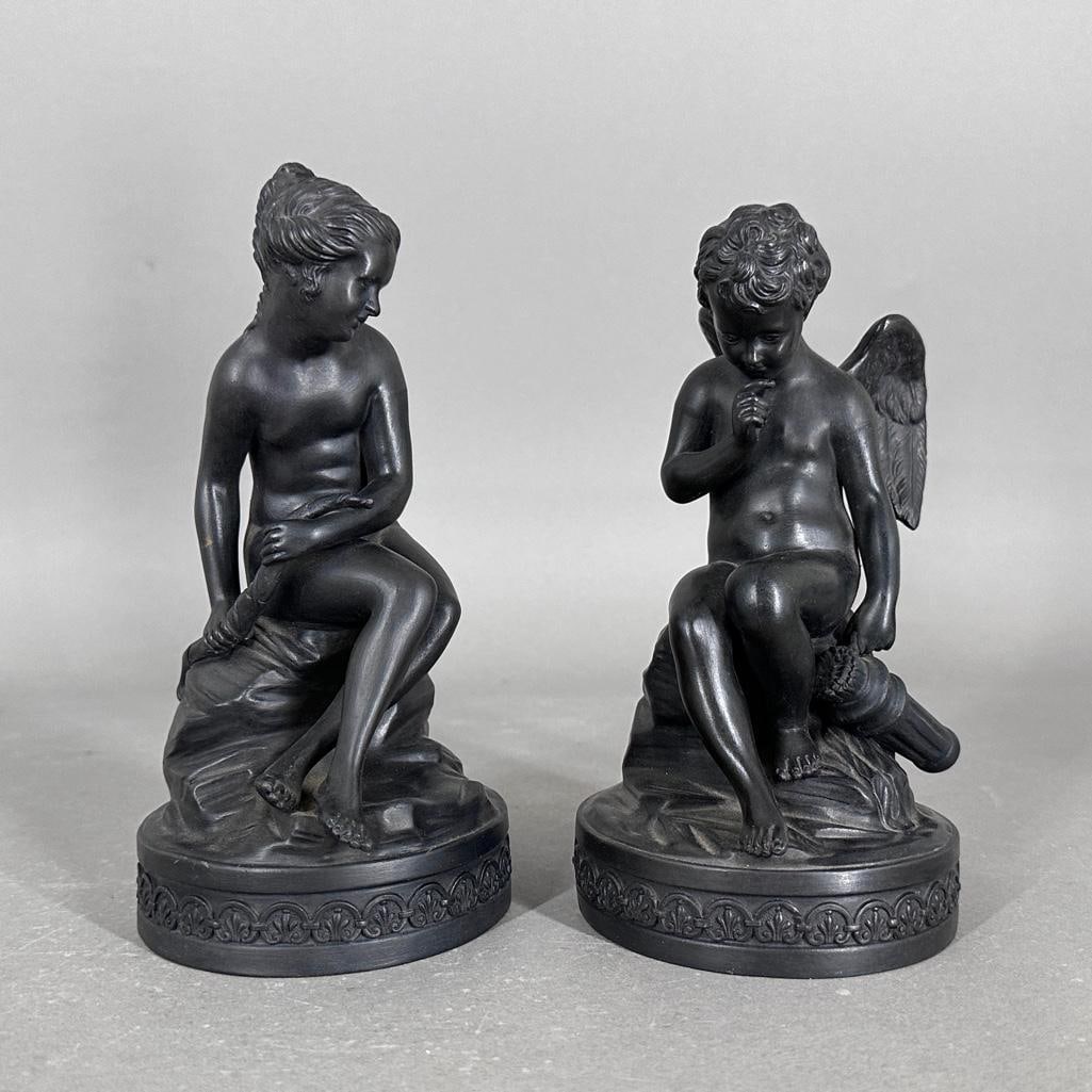 Wedgwood Black Basalt Figures of Cupid and Psyche, 18th/19thc.: Wedgwood Black Basalt Figures of Cupid and Psyche, 18th/19thc. Winged Cupid, seated, with his quiver of arrows, together with Psyche, seated, holding the bow, each on a circular anthemion molded base.