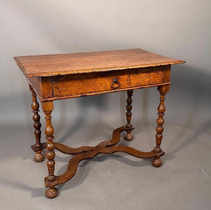 William and Mary Oak Writing Table, 17th/18thc.: William and Mary Oak Writing Table, 17th/18thc. Rectangular molded top over a single long drawer with wrought iron bail pull, over hand turned legs joined by an x-form stretcher on bun feet. Dimension