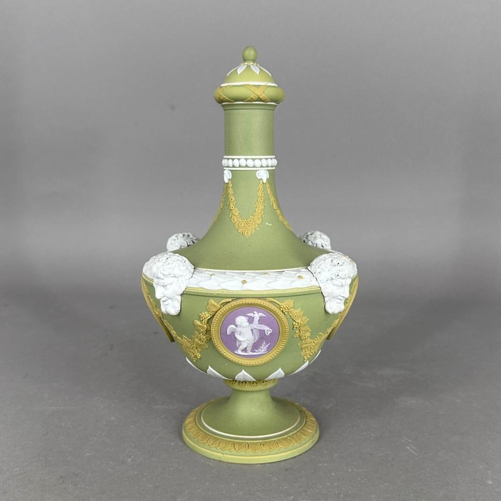 Wedgwood Four Color Jasper Dip Barber Bottle, 19thc.: Wedgwood Four Color Jasper Dip Barber Bottle, 19thc. Shouldered form on circular foot, the shoulders with four applied Bacchus masks, the body set with four oval medallions depicting cherubs emblemati