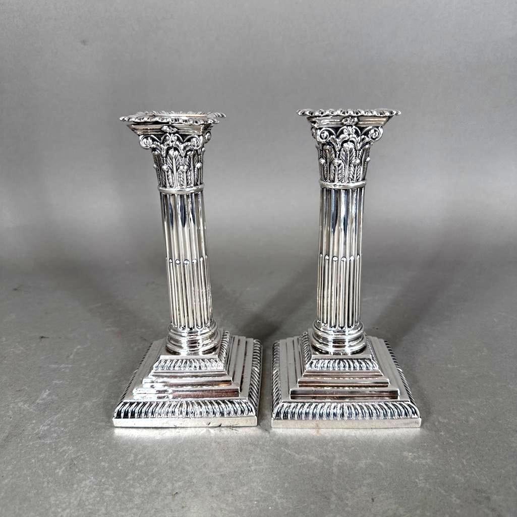 A Pair of British Sterling Silver Columnar Candlesticks, Sheffield: A Pair of British Sterling Silver Columnar Candlesticks, Sheffield, 1892, in the form of Corinthian columns, with fluted column and squared stepped bases. Hallmarked, with maker's marks for James 
