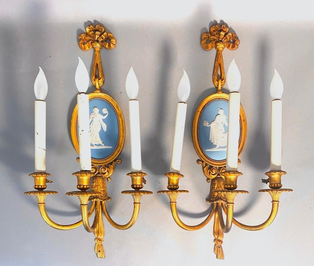 Pair of Gilt Bronze Three Light Wall Sconces Fitted with Wedgwood Jasper Plaques: Pair of Gilt Bronze Three Light Wall Sconces Fitted with Wedgwood Jasper Plaques, each cast in the form of an oval medallion suspended from a bow knot, the gilded frames enclosing pale blue Jasper rel