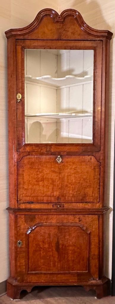 Queen Anne Corner Cabinet, English Walnut, ca. 1720: Queen Anne Corner Cabinet, English Walnut, ca. 1720, Molded broken arch pediment over glazed beveled door, the white painted interior with two shaped shelves, above a fall front door, the lower