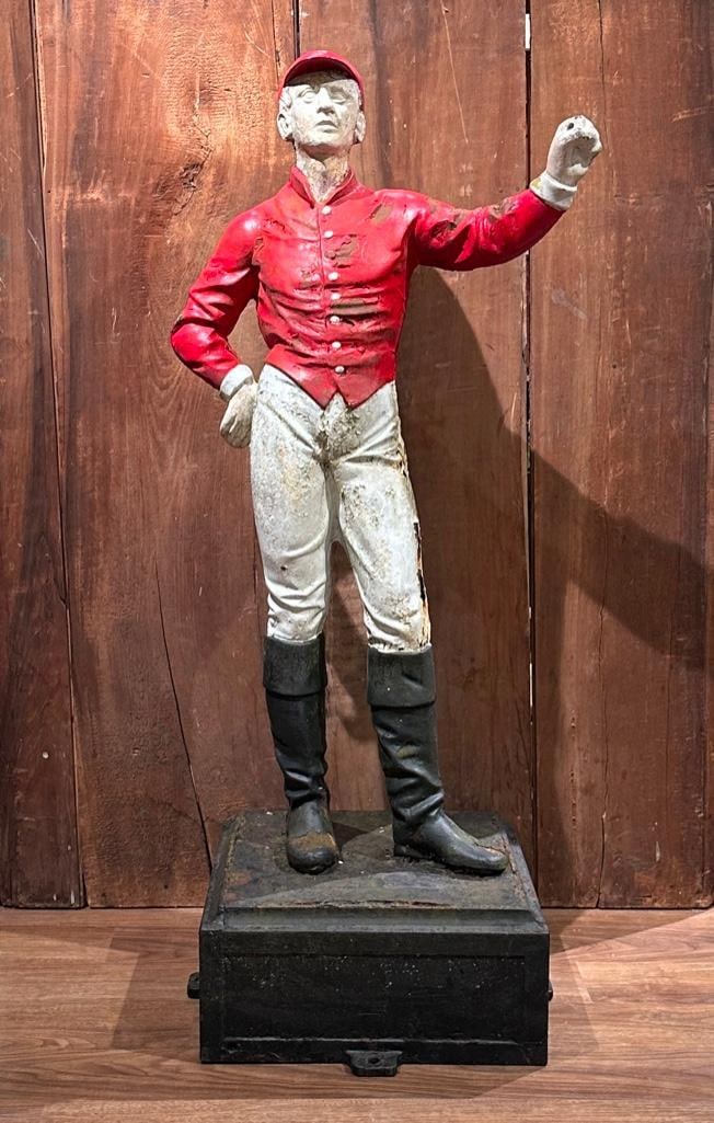 Vintage Cast Iron Hitching Post or Lawn Jockey: Vintage Cast Iron Hitching Post or Lawn Jockey, in red jacket and white jodphurs, raised on squared black painted cast iron base with holes for securing to ground. Dimensions: 46 in.h. Base measures 1